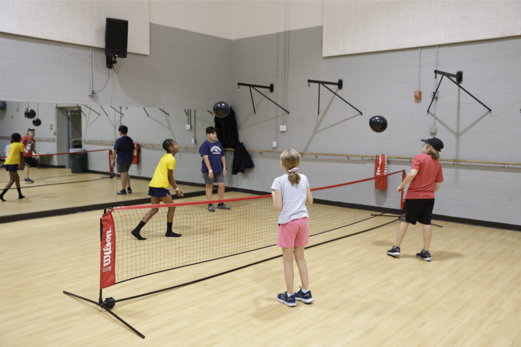 Four kids playing balloon volleyball at the nZone summer camp